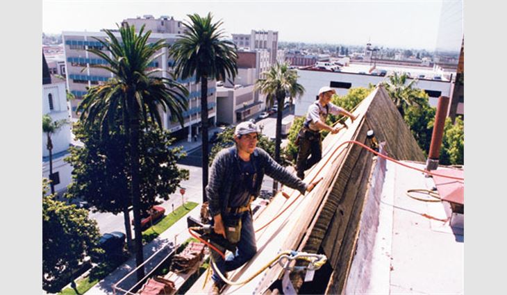 Roofing workers stood on toe boards and were tied-off in roof areas that have 10-in-12 (40-degree) slopes.