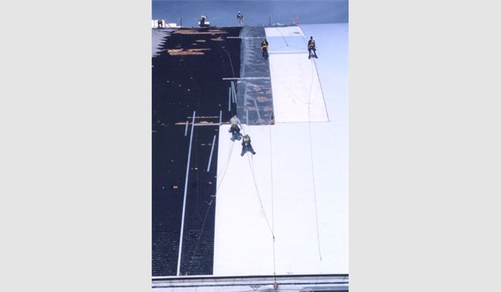 Roofing workers from NRCA member Cobra Roofing Services Inc., Spokane, Wash., wore proper fall protection when working on the Kibbie Dome at the University of Idaho, Moscow.