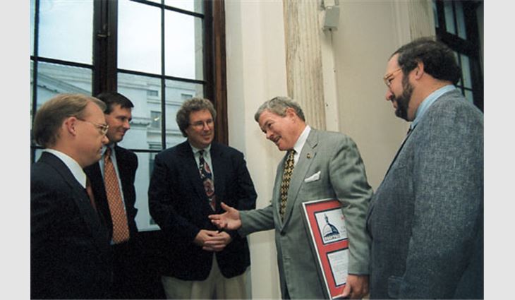 NRCA representatives present Sen. Christopher S. "Kit" Bond (R-Mo.) with ROOFPAC postcard. Pictured from left to right: Craig Brightup, NRCA's vice president of government relations; Bill Good, NRCA's executive vice president; Jamie McAdam, president of F.J. Dahill Co. Inc., New Haven, Conn.; Bond; and Steve Kruger, president of L.E. Schwartz & Son Inc., Macon, Ga. 