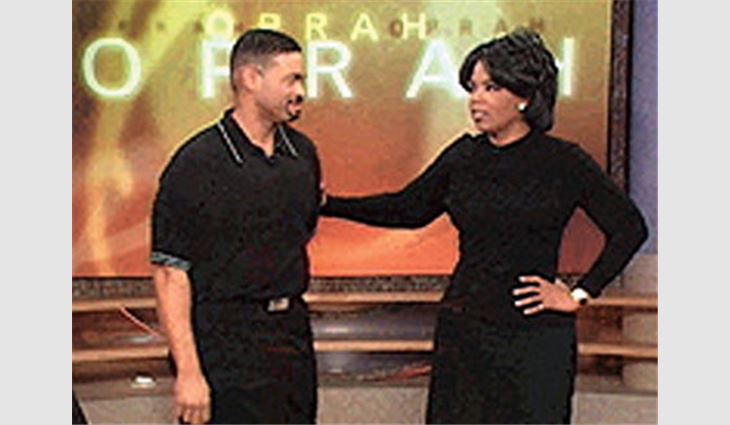 Hughes with Oprah Winfrey.