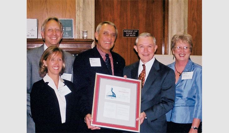 Don McCrory, president of Kiker Corp., Mobile, Ala., presents Sen. Jeff Sessions (R-Ala.) with a plaque from ROOFPAC as a way of saying "thanks" for his support. Pictured are (from left to right): Oscar Price III, president of All-South Subcontractors Inc., Birmingham, Ala.; Sandra Price; McCrory; Sessions; and Sandra McCrory.