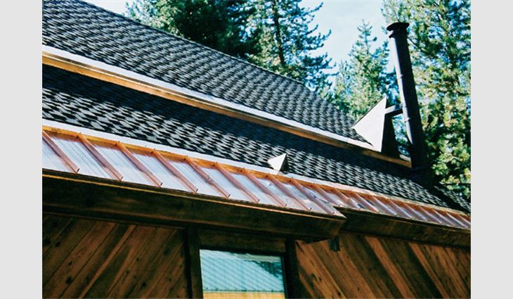 Flat and standing-seam copper panels, as well as trim and beam caps accentuate the shake asphalt shingle roof system.