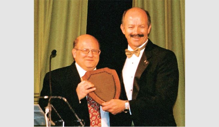 2002 J.A. Piper Award winner Conrad Kawulok (right), president of B & M Roofing of Colorado, Boulder, presented NRCA's counsel, Stephen Phillips, a partner with the law firm Hendrick, Phillips, Salzman & Flatt, Atlanta, with NRCA's 2003 J.A. Piper Award.