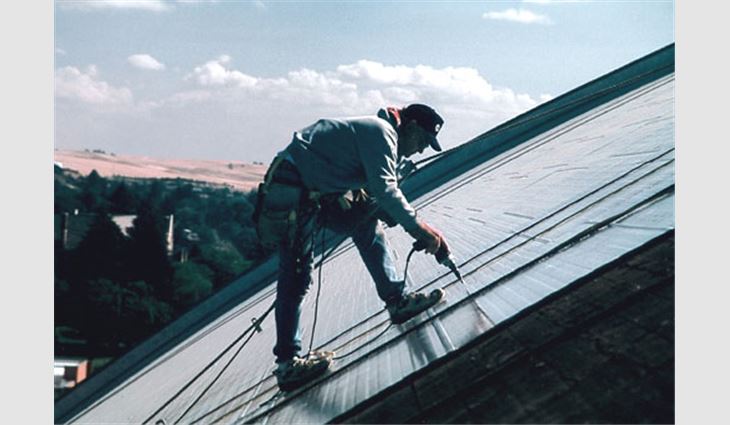 Working along the barrel-arch roof system's sides required roofing workers to wear full-body harnesses, rope grabs, and safety lines in compliance with the Occupational Safety and Health Administration.