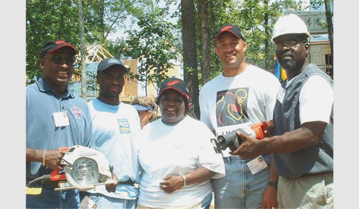 NFL players assist homeowners through Heavy Duty Helping. From left to right: retired Miami Dolphin Joe Cribbs; homeowners Terris and Katina Prince; retired Baltimore Raven David Marshall; and retired Tampa Bay Buccaneer, Bobby Howard.
