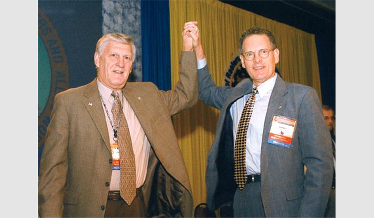 UURWAW International President John C. Martini (left) and UURWAW International Secretary/Treasurer Kinsey Robinson join hands as they pledge the union will move forward during the next five years.