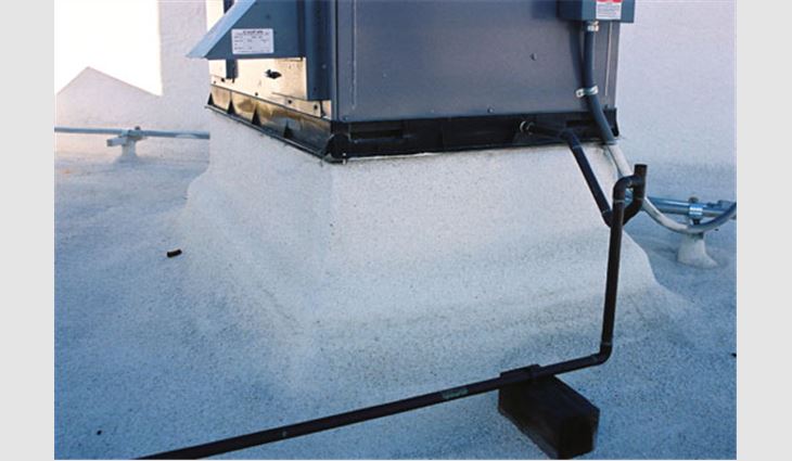 Both low and high equipment support curbs were observed as shown in Photos 9 and 10. In this photo, the high curb appears to have been extended up with a slightly smaller curb from the original base and flashed with SPF and coating. 