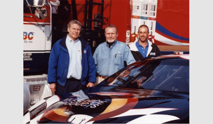 Johnny Cline (left), operations manager of Petty Enterprises, Level Cross, N.C.; Tim Allen (center), president of McRae Roofing Inc., Asheboro, N.C.; and Jim Skelley, project manager for McRae Roofing, pose near the Beloit, Wis.-based Mule-Hide Products' sponsored racecar.