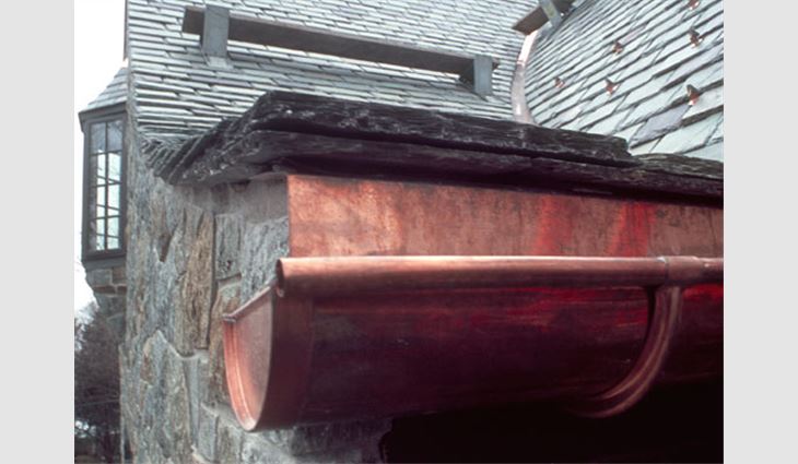 This slate eave construction includes integrating the slate roof system with a soldered flat-seam copper roof, an eave cant method that incorporates a receiver for the metal roof, underlayment system for a cold climate and low slope at the swept eave. 