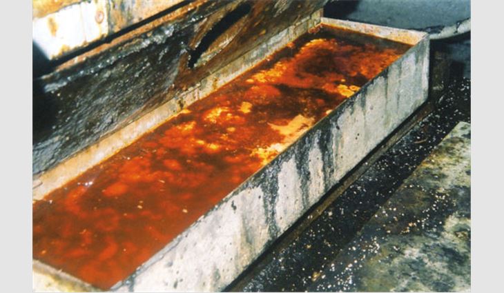 This photo shows a standard rooftop grease trap full of animal fat and grease.