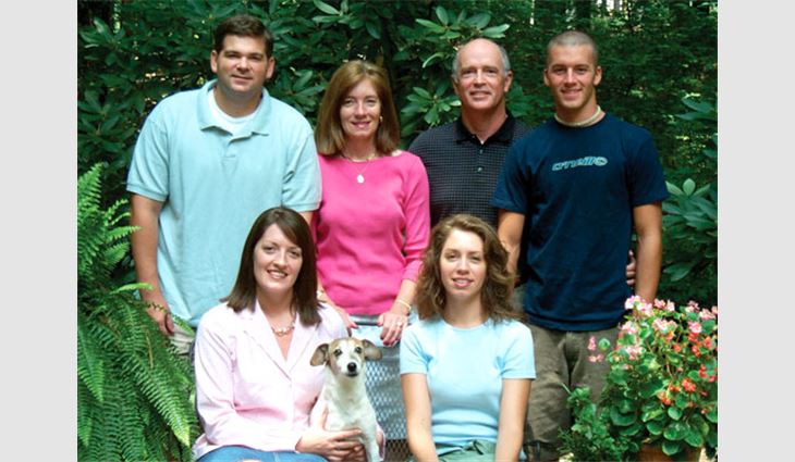 McClure, president of Membrane Systems Inc., Atlanta, with his family. Pictured from left to right (front): daughter Courtney, dog Razz and daughter Kerri. Pictured from left to right (back): son-in-law Ron DeFeo, wife Mimi, McClure and son Drew.