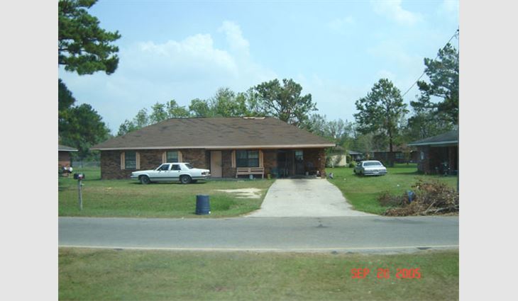 This house in Picayune, Miss., is about 25 miles (40 km) north of the coast. The newer three-tab asphalt shingles lost a number of tabs along their butt edges.
