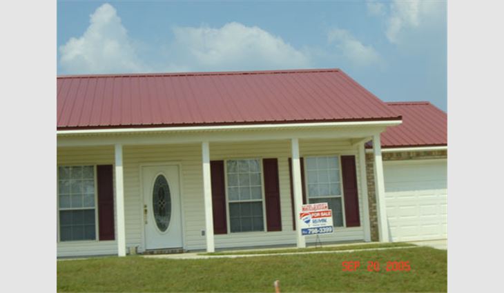 Photo 14. This structure, located north of the central business district in a new subdivision of Picayune, Miss., is about 25 miles (40 km) north of the coast. The metal panel roof system was not damaged during the hurricane.