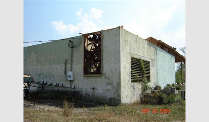Photo 17. This structure, located north of Picayune, Miss., along Route 11 is about 30 miles (48 km) north of the coast. This is the northwest corner of the building in Photos 15 and 16 and is the point where the roof assembly's failure was initiated. The fans and louver allowed high winds to enter the heating, ventilating and air-conditioning equipment room, which created internal pressure and lifted the corner of the roof assembly. Once the roof assembly lifted, the high winds folded it over upon itself. Close inspection of the top of the masonry wall showed a lack of mechanical attachment (J bolts), which should have helped secure the roof assembly to the top of the wall.