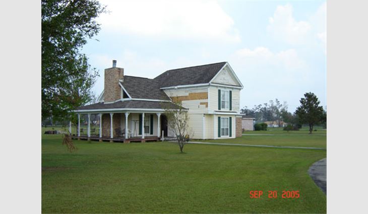 Photo 6. This house is about 25 miles (40 km) north of the coast along Route 43 and is located in Plantation Oaks subdivision east of Picayune, Miss. The newer asphalt shingle roof system fared well. The siding was damaged during the hurricane.