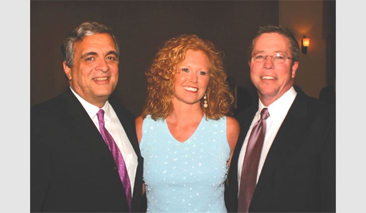 Former CIA Director George Tenet greets Robert Daly Jr., president of Kaw Roofing and Sheet Metal Co. Inc., Kansas City, Kan., and his wife, Kelly. 
