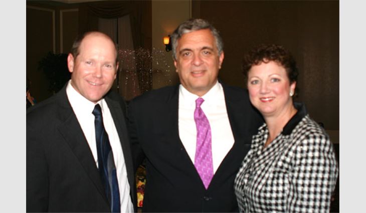 Tenet poses with NRCA Senior Vice President Reid Ribble, president of The Ribble Group, Kaukauna, Wis., and his wife, DeaNa.