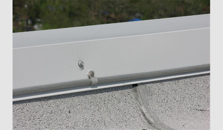 This conductor was attached to the coping with a looped connector. When sufficiently long screws are used, this is an effective attachment technique.

