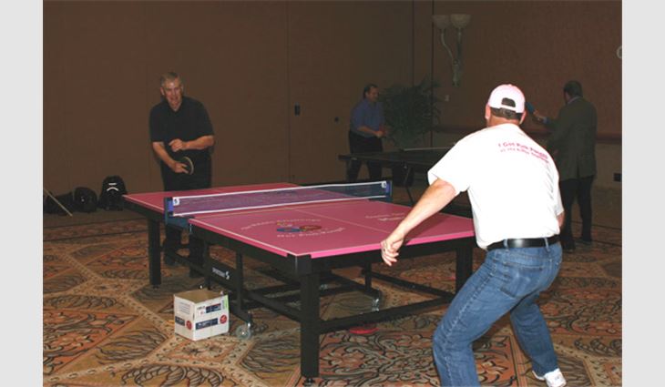NRCA President Reid Ribble, president of The Ribble Group Inc., Kaukauna, Wis., is challenged to a game of ping-pong by Bob Bueche, president of Pioneer Roofing Co., Phoenix.