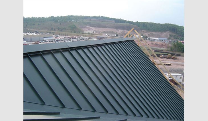 The ridge vent and cap shown are designed to be installed before the roofing panels are installed. This has proved to be a watertight system that can be applied more efficiently and safely than ridge caps that are installed after panel installation.
