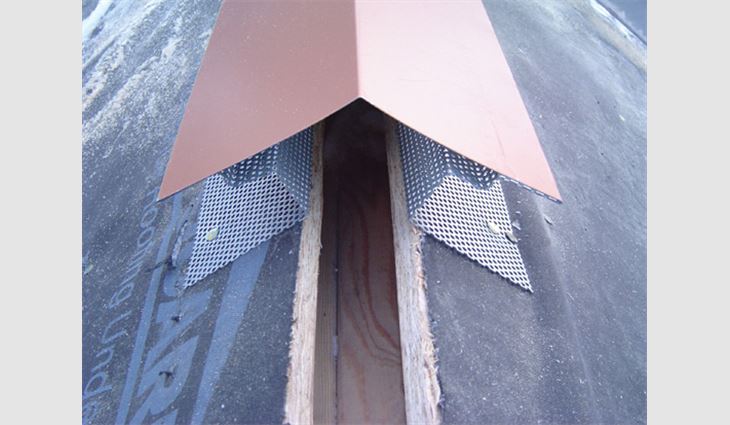 Each 10-foot (3-m) length of vented ridge cap is composed of two perforated C channels and a section of cap fabricated from the same coil material and color with which the roofing pans are made. The cap is crimped onto the vented C channels on the job before each section of ridge is installed. The ridge is affixed to the roof deck with screws or roof nails through the edge of the perforated stock that extends past the cap on each side.
