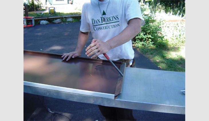 The roofing pans are "box panned" before they are installed into the ridge, and baffles are applied to prevent wind from driving water and snow directly into the perforations in the C channels.
