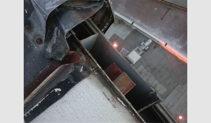 A view of the damaged expansion joint at the coping cap