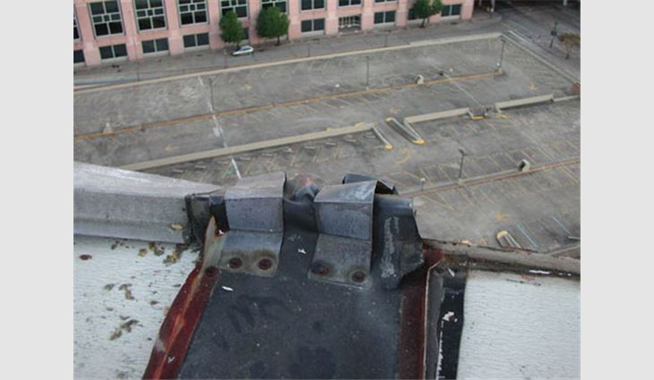 A view of missing metal coping cap at the expansion joint