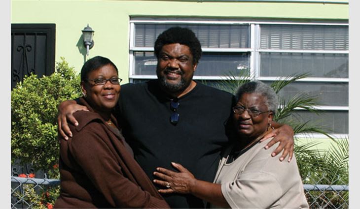 Thelma Walker (far right), a Miami homeowner whose home was damaged during Hurricane Wilma, with her family
