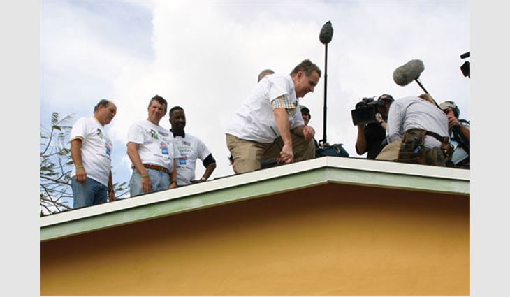 Pictured from left to right: Billy Cone, president of RoofTech Roofing & Sheet Metal, Fort Lauderdale, Fla.; Bill Good, NRCA's executive vice president; Gary Officer, Rebuilding Together's president and chief executive officer; and Paul Tagliabue, former NFL commissioner, help repair Walker's home