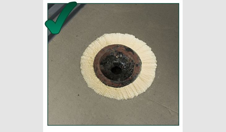 This photo shows a shaved sump for a single-ply system. Single-ply membranes can accommodate drastic angle changes because of the flexibility of unreinforced membranes. This single-ply system was applied after tearing off a bituminous system (note the asphalt in the drain cavity).