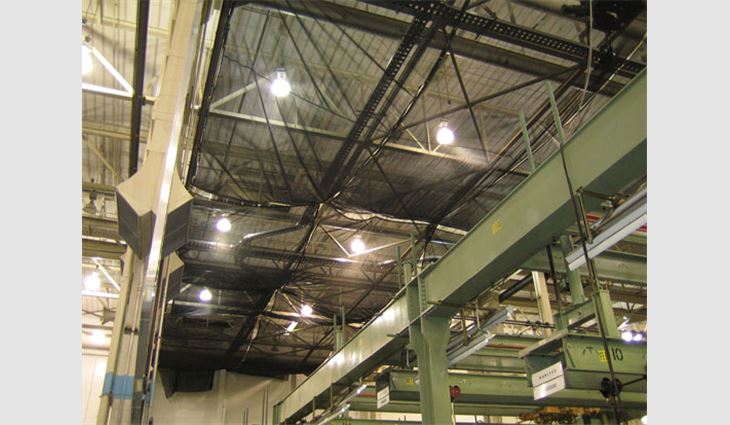 Tarps protected operations inside the maintenance facility.