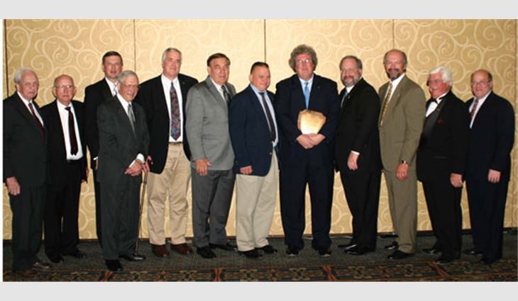 Jamie McAdam, president of F.J. Dahill Co. Inc., New Haven, Conn., and recipient of the 2007 J.A. Piper Award, stands with previous J.A. Piper Award winners. Pictured from left to right: Robert (Country) Harrison, former president of Greenville Roofing Company Inc., Greenville, S.C.; Charlie Raymond; NRCA Executive Vice President Bill Good; Melvin Kruger, chief executive officer (CEO) of L.E. Schwartz & Son Inc., Macon, Ga.; Charles (Rusty) Griffiths Jr., president of Binghamton Slag Roofing Co. Inc., Binghamton, N.Y.; Marlin Potteiger, CEO of Potteiger-Raintree Inc., Glen Rock, Pa., a Tecta America company; Dick Baxter, president of CRS Inc., Monroe, N.C.; McAdam; Steven Kruger, president of L.E. Schwartz & Son; Conrad Kawulok, president of B & M Roofing of Colorado Inc., Frederick; Johnny Zamrzla, president of Western Pacific Roofing Corp., Palmdale, Calif.; and Stephen M. Phillips, partner with Hendrick, Phillips, Salzman & Flatt, Atlanta.
