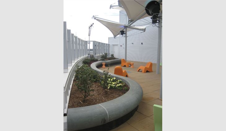 EPDM tiles and small green roof planters were installed on this rooftop play area on Levine Children's Hospital's 12th floor.