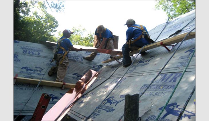 CMR Construction & Roofing workers install 16-ounce copper metal valleys.