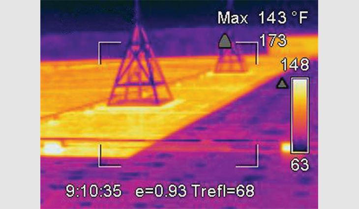 An infrared scan shows the lower temperature of the coated portion of this EPDM roof.