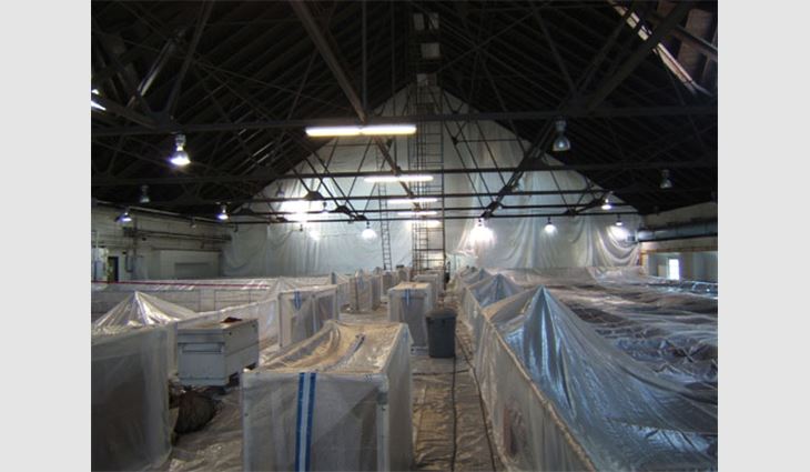 The north/south filter building's interior was divided into sections by plastic curtains hung from the ceiling so the water filtration beds could be kept running as roofing work was performed.