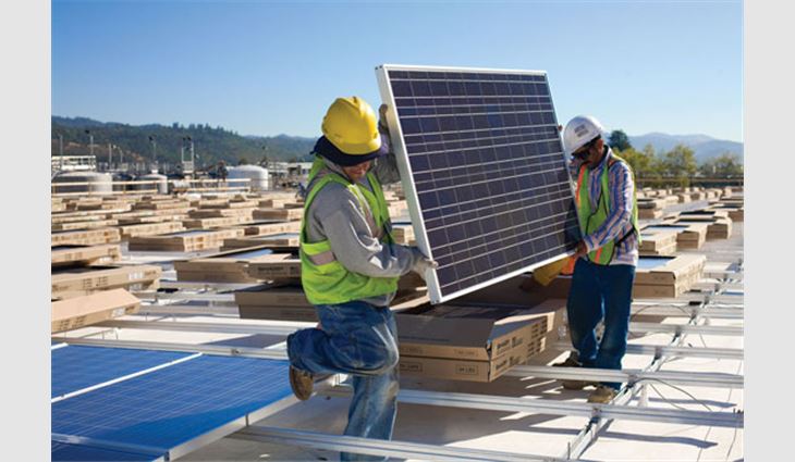 Stellar Energy Solutions employees install a solar module.