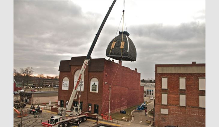 The cupola being raised to Tibbits Opera House's rooftop 
