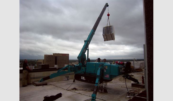 The crew used a Maeda Mini Crane to lift materials to the rooftop and lower tear-off debris to the ground.