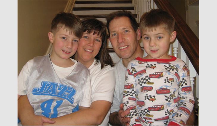 Clark with his wife, Laura, and sons Carson (left) and Cameron (right)