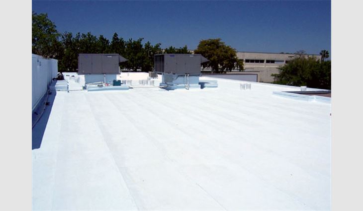 This building's roof system has one coat of a white elastomeric coating. A second coat will hide the substrate, so it will look like a single monolithic white membrane.