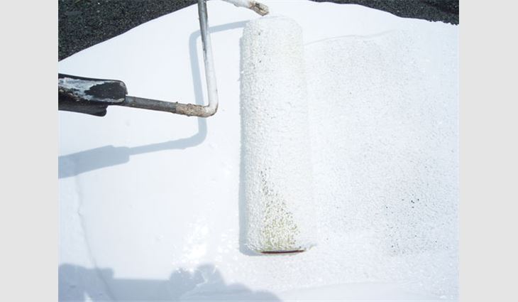 A white elastomeric coating is applied with a roller.