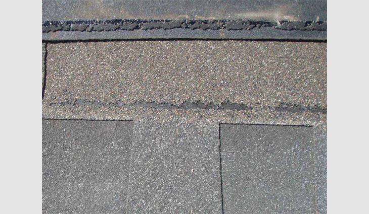 Photo 3: The sealant on this shingle has great adhesive and cohesive strength-enough to pull plugs out of the coating.