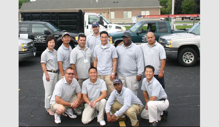 Lee (middle row, third from the right) with J & K Home Improvement employees