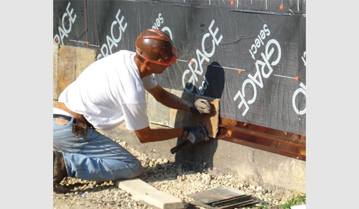 A worker installs the starter strip.