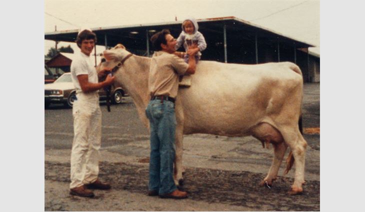 Heilinger (center) with his son and grandchild at a dairy show