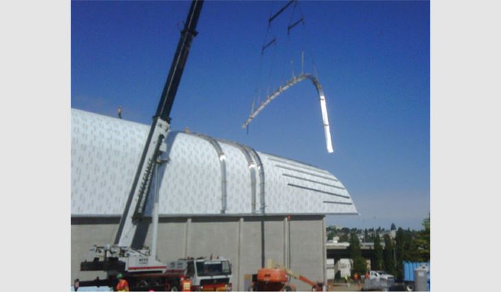 A crane and custom-designed crating system were used to load the materials to the roof