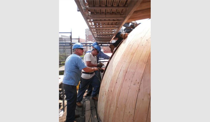 Crew members work on one of the small dome's structural deck.