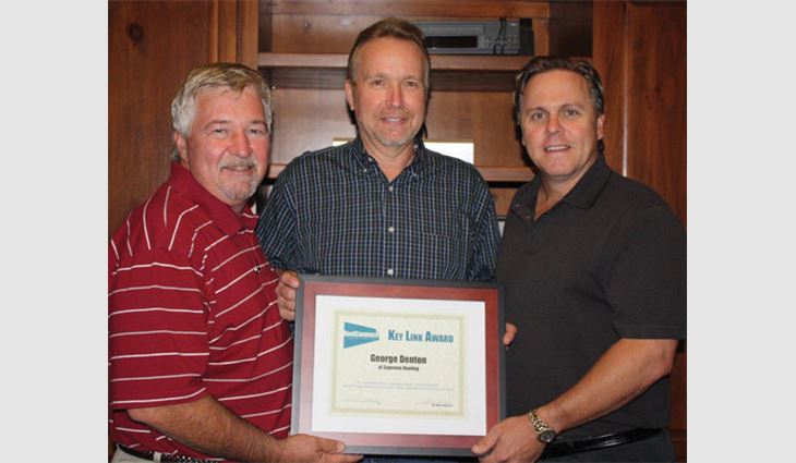 Pictured from left to right: Tim Rainey, president of Supreme Systems; Denton; and Jeff Sterrett, chief financial officer of Supreme Systems, after Denton won the RoofConnect Key Link Award